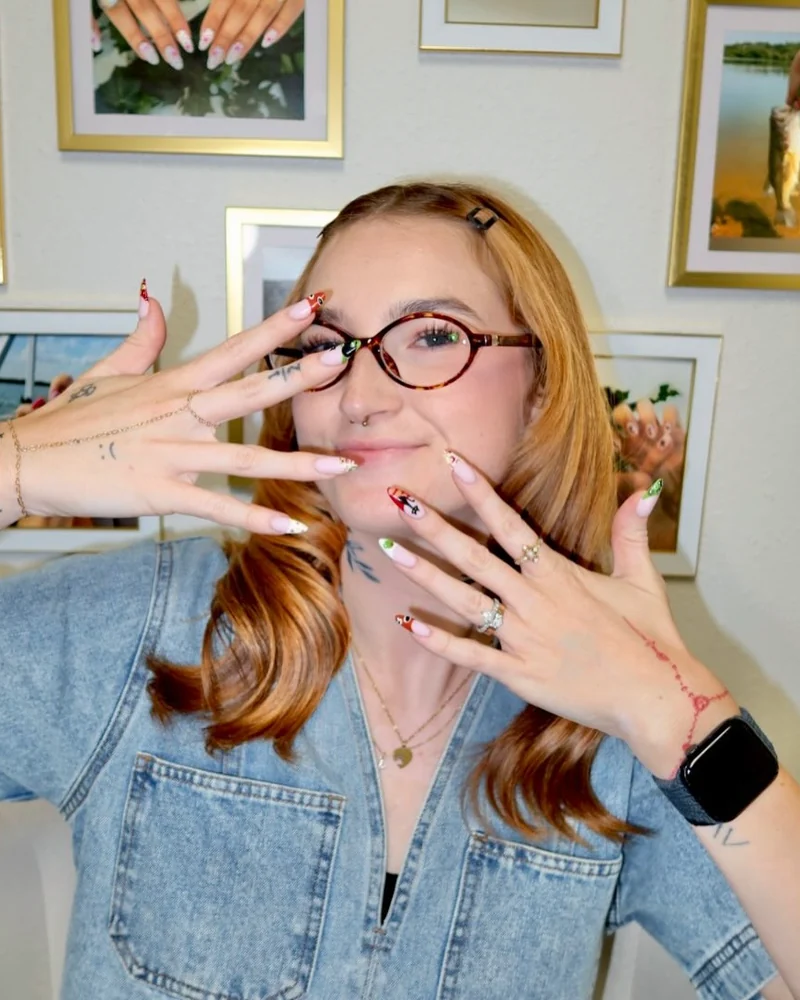 Camryn showing a fresh set of hand-painted nails